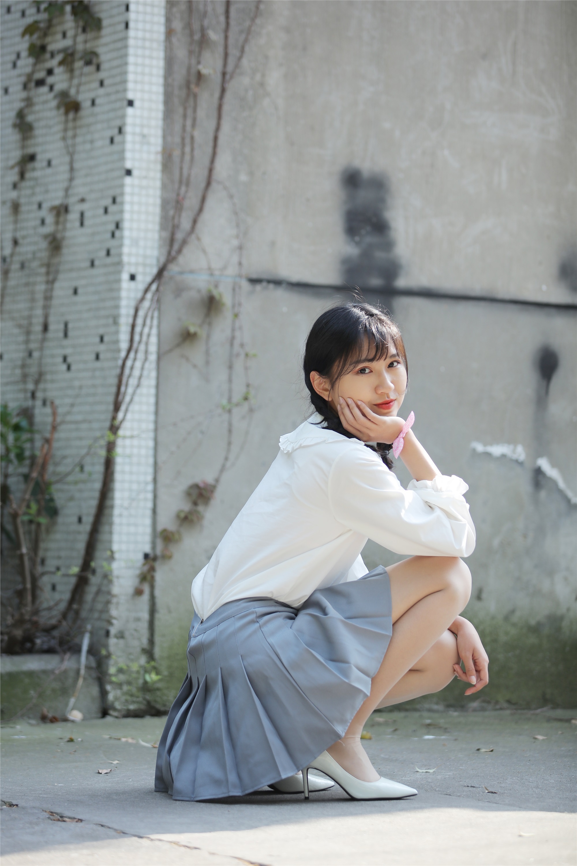 Little Orange with ponytail and white pleated skirt